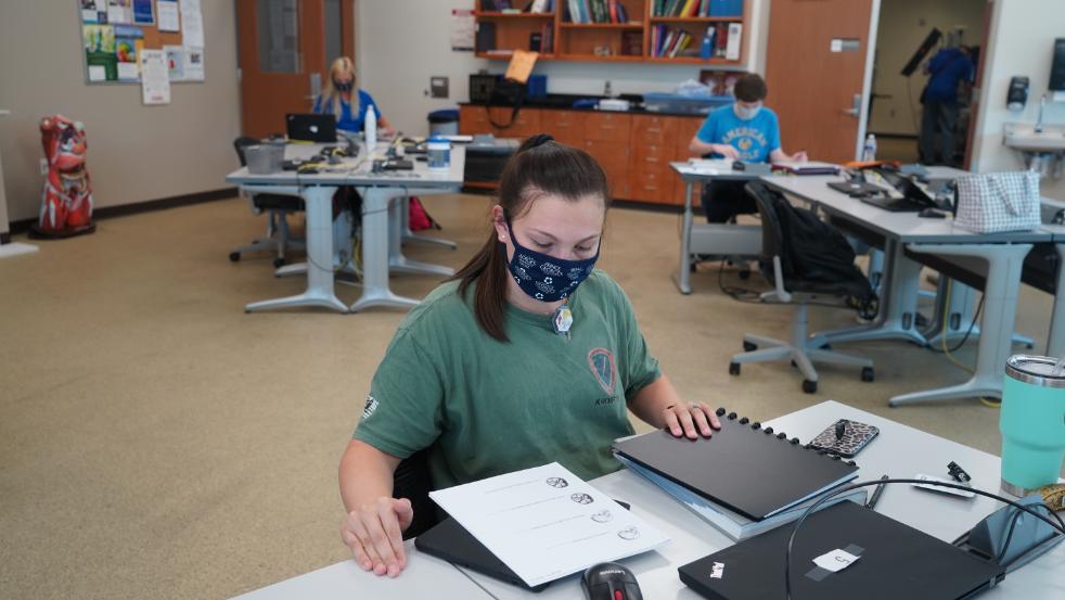 Student with face mask working at desk