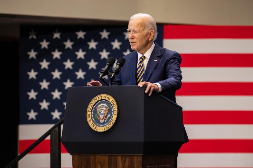 U.S. President Joe Biden speaks on a podium inside the Center for Performing Arts at Prince George's Community College.