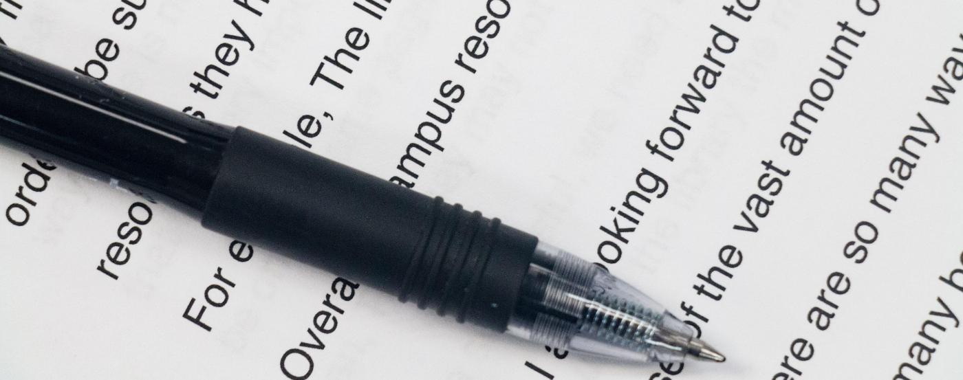 Close up Shot of a Student's Essay and a Pen